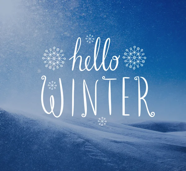 Photo of snowstorm in sunny day with Hello Winter lettering.