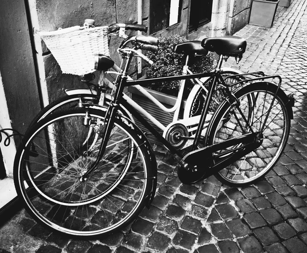 Two classic vintage retro city bicycles, bw photo, Rome, Italy