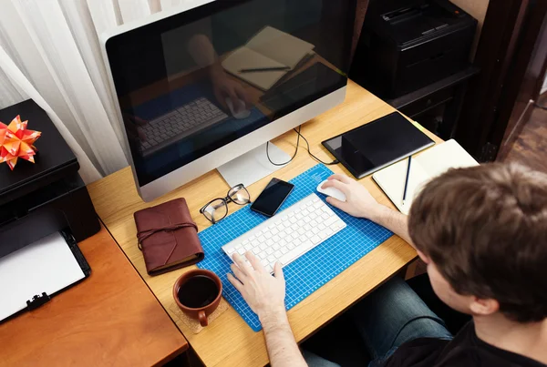 Freelance developer and designer working at home, man using desk