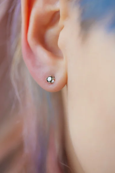 Woman's ear wearing a beautiful earring