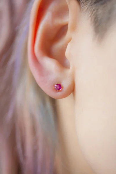 Woman's ear wearing a beautiful earring