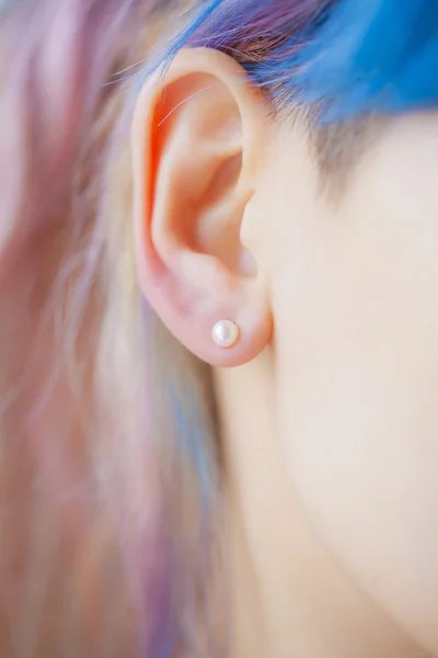 Woman's ear wearing a beautiful earring