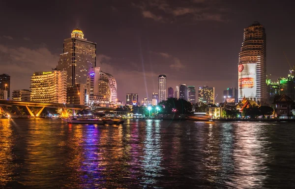 Night view of the river and buildings in Bangkok with night illumination