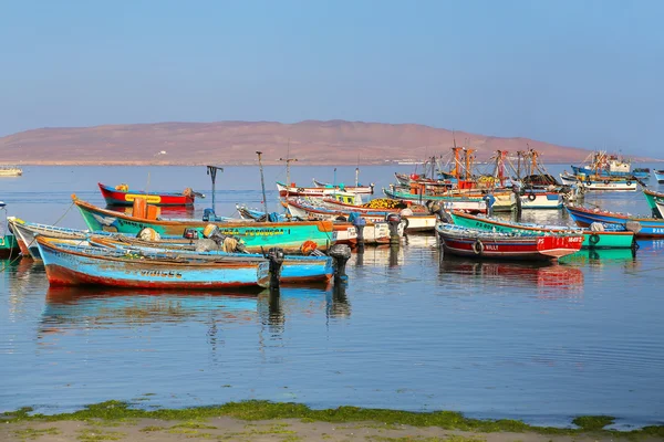 PARACAS, PERU-JANUARY 26: Colorful fishing boats anchored in Paracas Bay on January 26, 2015  in Paracas, Peru. Paracas is a small port town catering to tourists visiting Paracas Reserve and Ballestas islands.