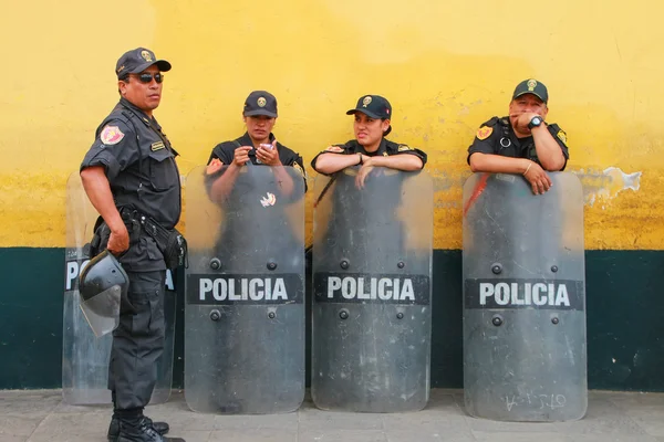 LIMA, PERU-JANUARY 31: Unidentified policemen standwith riot shields  on January 31, 2015 in Lima, Peru. Peruvian National Police is one of the largest police forces in South America.