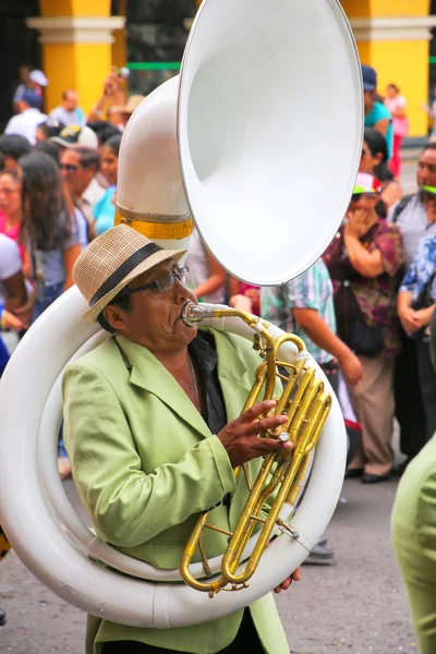 LIMA, PERU-FEBRUARY 1: Unidentified man plays sousaphone during Festival of the Virgin de la Candelaria on February 1,2015 in Lima, Peru. Core of the festival is dancing performed by dance schools