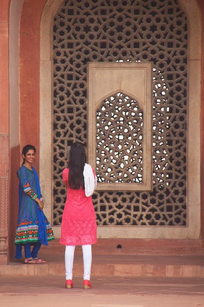 DELHI, INDIA - NOVEMBER 4: Unidentified women take photos at Humayun\'s Tomb on November 4, 2014 in Delhi, India. Humayun\'s Tomb was the first garden-tomb on the Indian subcontinent.