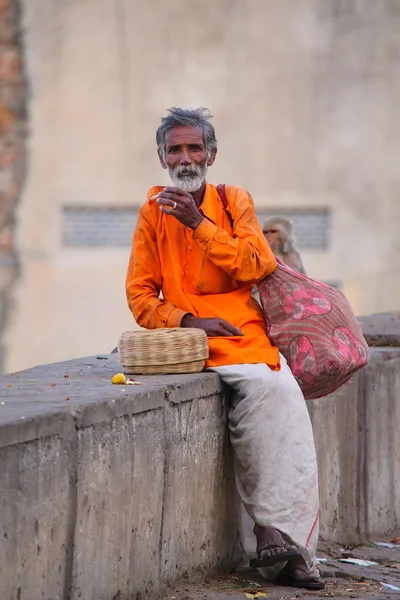 JAIPUR, INDIA - NOVEMBER 14: Unidentified man sits on a stone wall on November 14, 2014 in Jaipur, India. Jaipur is the capital and largest city of the Indian state of Rajasthan.
