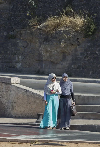 Traditional clothed women crossing the road