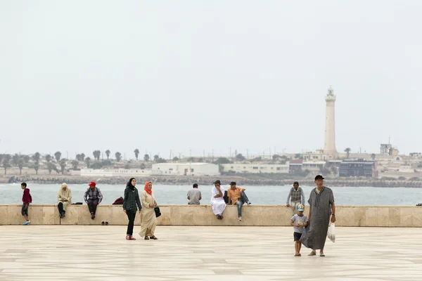 Local people walking on the ramparts near of King Hassan II Mosque