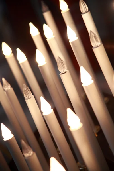 Lighted candles in the cathedral of Pisa c