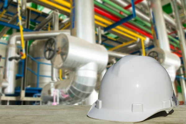 Safety engineering and a helmet resting on the details of refrigeration compressors.