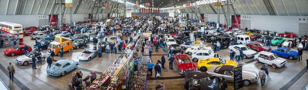 Panoramic view on a different cars and bikes in the exhibition hall.