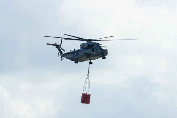 Heavy-lift cargo helicopter Sikorsky CH-53 Sea Stallion of the German Army with equipment for fighting fires