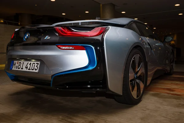 BERLIN - NOVEMBER 28, 2014: Showroom. The BMW i8, first introduced as the BMW Concept Vision Efficient Dynamics, is a plug-in hybrid sports car developed by BMW. Rear view.
