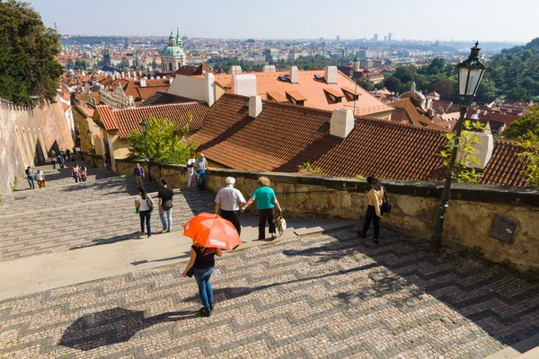 Tourists on the stairs leading to the Prague Castle. District of the Lesser Town (Mala Strana). Prague is the capital and largest city of the Czech Republic.