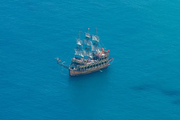 ALANYA, TURKEY - JULY 09, 2015: Mediterranean Sea. Traditional entertainment resort of Alanya. Sailing aka pirate ships around the fortress of Alanya. View from the bird\'s-eye view.