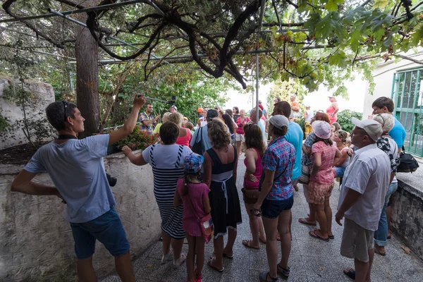 Group of tourists in the ruins of the fortress of Alanya listening to the guide.