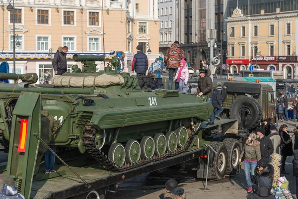 Children play on modern russian armored vehicle.