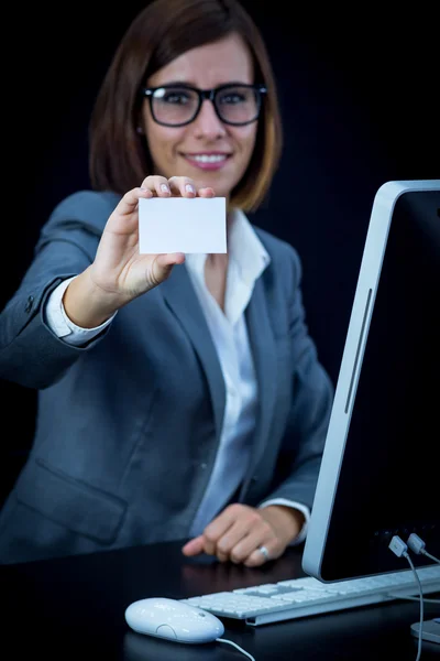 Woman works at the computer and showing a blank card