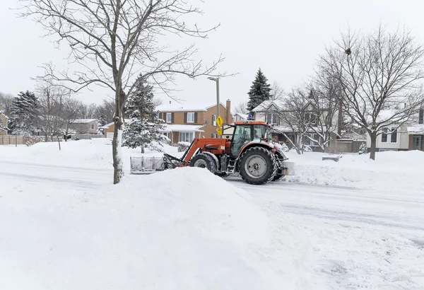 Snow Plow Going Through a Suburban Neighborhood