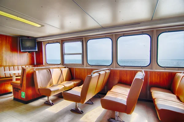 Ferry boat cabin and rows of seats looking out the window