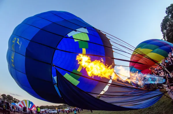 Fire heats the air inside a hot air balloon at balloon festival