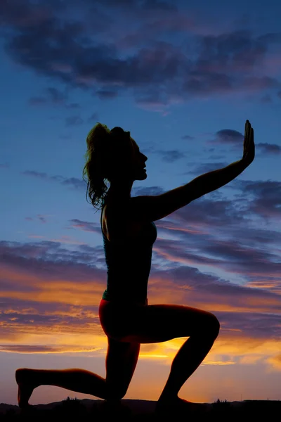 Silhouette of exercising woman outdoors