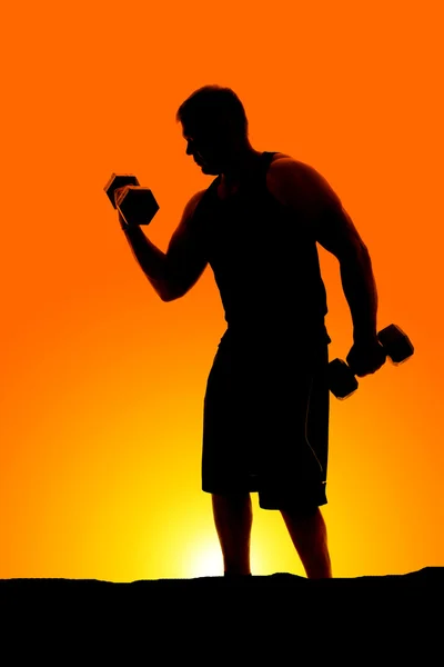 Silhouette of man exercising outdoors