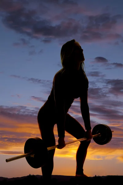 Silhouette of fit woman barbell deadlift