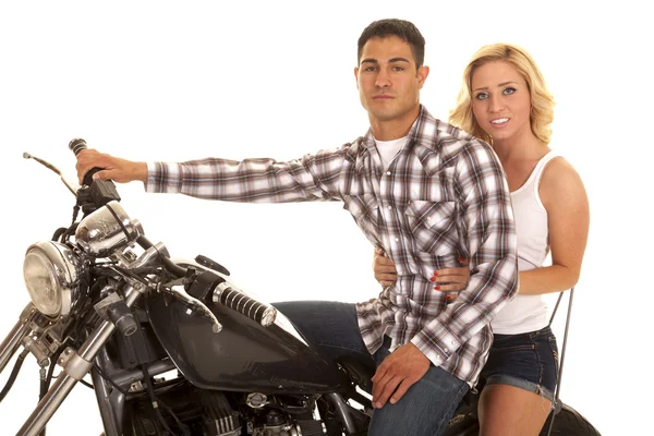 Western couple sitting on motorcycle