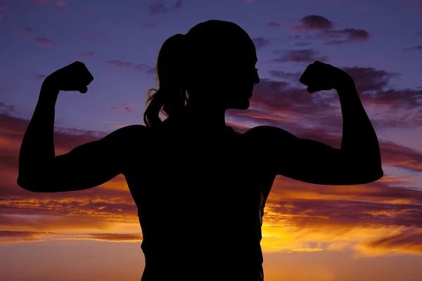 Silhouette of woman showing muscles