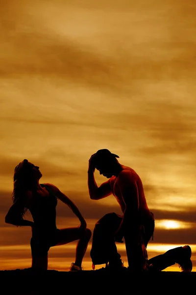 Silhouette of cowboy and woman