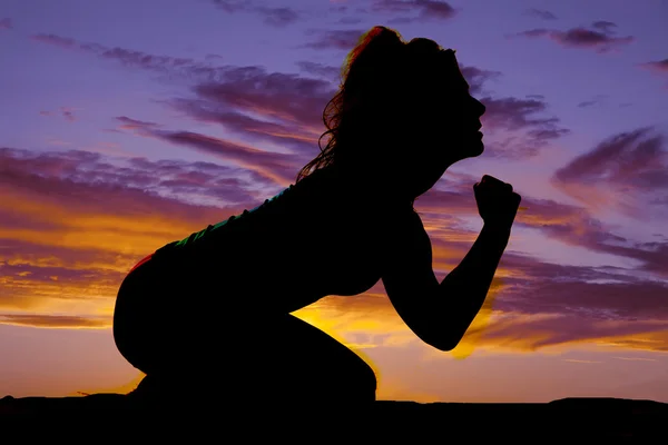 Silhouette of woman at sunset sky