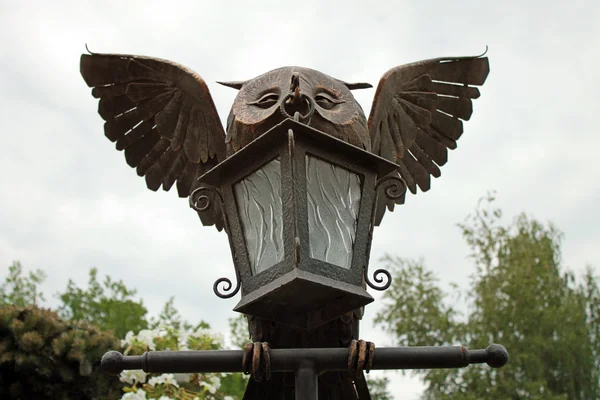 Lantern bronze owl statue in the park.