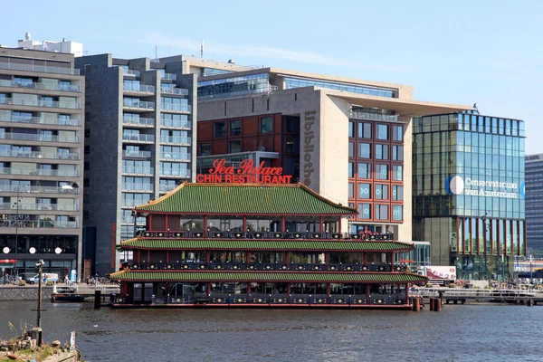 Chinese restaurant and modern buildings on canal, Amsterdam, Net