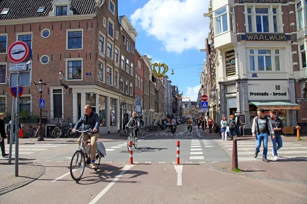 Local people on bicycle in historical center in Amsterdam