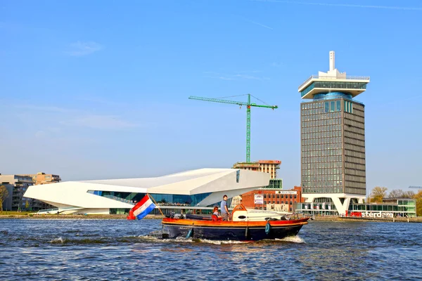 People in a boat and EYE Film Institute and Overhoeks Tower in Amsterdam