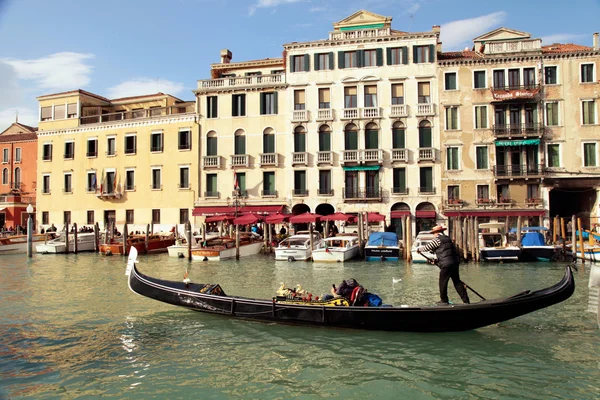 Gondolier rides gondola on the Grand Canal, Venice