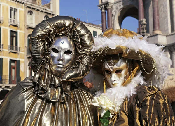 Masked persons in costume on Carnival in Venice, Italy.