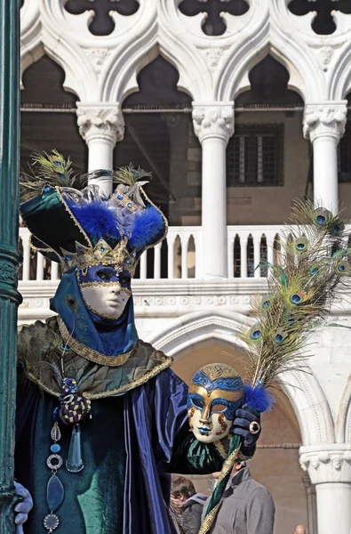 Costumed people in Venetian mask during Venice Carnival, Italy