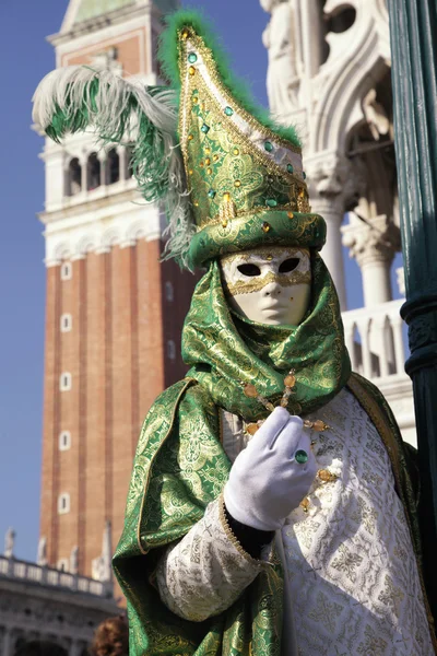 Costumed people in Venetian mask during Venice Carnival, Italy