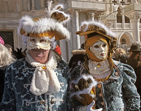 Masked persons in costume on San Marco Square in Venice, Italy.