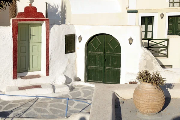 Traditional houses with green doors in Oia, Santorini island