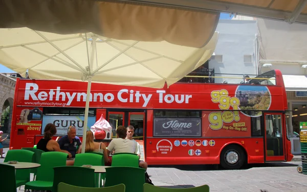 City tour bus and people in Old Town of Rethymno, Crete, Greece.