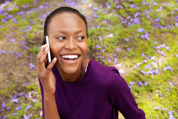 Beautiful young african woman using cell phone
