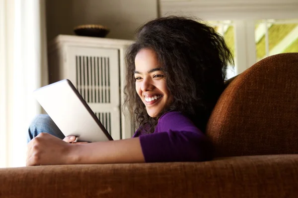Mixed race woman looking at digital tablet