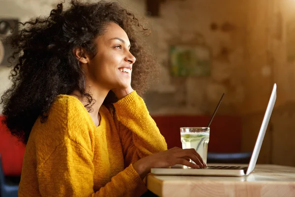 Smiling young woman with laptop