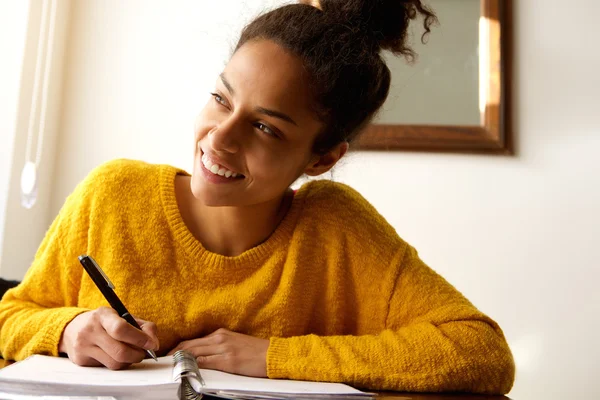 Smiling young woman with notebook