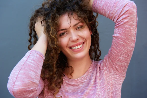 Happy teen with hands in hair